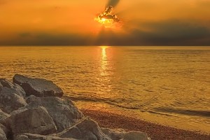 Setting Sun Behind Lone Cloud